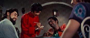 Movie still from “The Way of the Dragon” (1972), directed by Bruce Lee – A man and a woman sitting at a dinner table; Medium shot, Over the shoulder angle