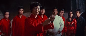 Movie still from “The Way of the Dragon” (1972), directed by Bruce Lee – A group of people standing in front of each other; Medium shot, Low angle
