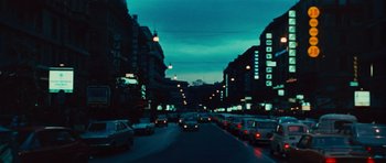 Movie still from “The Way of the Dragon” (1972), directed by Bruce Lee – A city street filled with lots of traffic at night; Extreme Wide shot, Low angle