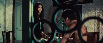 Movie still from “The Way of the Dragon” (1972), directed by Bruce Lee – A man and a woman sitting at a dinner table; Medium shot, Over the shoulder angle