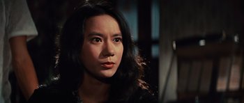 Movie still from “The Way of the Dragon” (1972), directed by Bruce Lee – A person with long black hair; Close Up shot, High angle