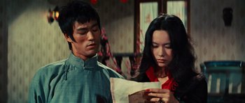 Movie still from “The Way of the Dragon” (1972), directed by Bruce Lee – A man and a woman looking at a piece of paper; Medium shot, Over the shoulder angle