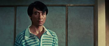 Movie still from “The Way of the Dragon” (1972), directed by Bruce Lee – A man standing in front of a wall; Close Up shot, Over the shoulder angle