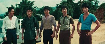 Movie still from “The Way of the Dragon” (1972), directed by Bruce Lee – A group of young men standing next to each other; Medium shot, Low angle