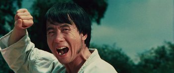 Movie still from “The Way of the Dragon” (1972), directed by Bruce Lee – A person with his mouth wide open; Close Up shot, Low angle
