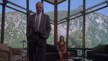 Movie still from “The Way of the Gun” (2000), directed by Christopher McQuarrie – A man and a woman sitting in front of each other; Wide shot, Low angle