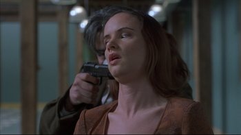 Movie still from “The Way of the Gun” (2000), directed by Christopher McQuarrie – A man holding a gun over a woman's face; Close Up shot, Over the shoulder angle