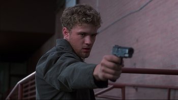 Movie still from “The Way of the Gun” (2000), directed by Christopher McQuarrie – A man holding a gun in his hand; Close Up shot, Low angle