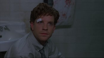 Movie still from “The Way of the Gun” (2000), directed by Christopher McQuarrie – A man with a bandage on his head; Close Up shot, Over the shoulder angle