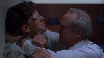 Movie still from “The Way of the Gun” (2000), directed by Christopher McQuarrie – Two men fighting with each other with blood on their eyes; Close Up shot, Low angle