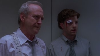 Movie still from “The Way of the Gun” (2000), directed by Christopher McQuarrie – Two men with blood on their faces and one has a blood spatter on his face; Close Up shot, Low angle