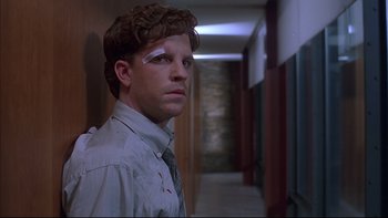 Movie still from “The Way of the Gun” (2000), directed by Christopher McQuarrie – A man with a bandage on his head; Close Up shot, Low angle