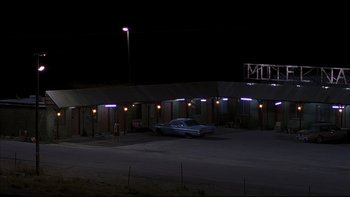 Movie still from “The Way of the Gun” (2000), directed by Christopher McQuarrie – A car parked in front of a motel at night; Extreme Wide shot, Low angle