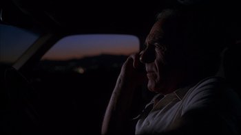 Movie still from “The Way of the Gun” (2000), directed by Christopher McQuarrie – An older man sitting in the back seat of a car at night; Close Up shot, Low angle