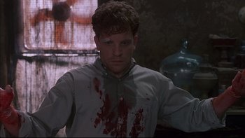 Movie still from “The Way of the Gun” (2000), directed by Christopher McQuarrie – A man with blood all over his face and neck; Medium shot, Low angle