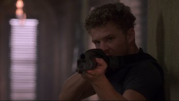 Movie still from “The Way of the Gun” (2000), directed by Christopher McQuarrie – A man holding a gun in his hands; Close Up shot, Low angle