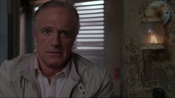 Movie still from “The Way of the Gun” (2000), directed by Christopher McQuarrie – An older man in a white shirt and jacket; Close Up shot, High angle