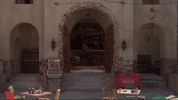 Movie still from “The Way of the Gun” (2000), directed by Christopher McQuarrie – An entrance to an old fashioned soda fountain; Wide shot, High angle