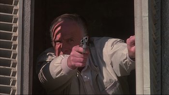 Movie still from “The Way of the Gun” (2000), directed by Christopher McQuarrie – An older man holding a gun in his hand; Close Up shot, Low angle