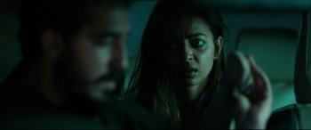 Movie still from “The Wedding Guest” (2018), directed by Michael Winterbottom – A man and a woman in a dark room; Close Up shot, Over the shoulder angle