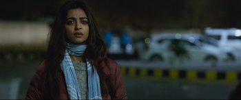 Movie still from “The Wedding Guest” (2018), directed by Michael Winterbottom – A woman with long brown hair wearing a blue scarf; Close Up shot, Over the shoulder angle