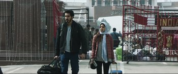 Movie still from “The Wedding Guest” (2018), directed by Michael Winterbottom – A man and a woman walking down a street; Medium shot, Low angle