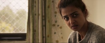 Movie still from “The Wedding Guest” (2018), directed by Michael Winterbottom – A person looking at the camera; Close Up shot, Over the shoulder angle