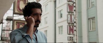 Movie still from “The Wedding Guest” (2018), directed by Michael Winterbottom – A person talking on a cell phone; Close Up shot, Low angle