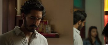 Movie still from “The Wedding Guest” (2018), directed by Michael Winterbottom – A man standing in front of a bathroom mirror; Close Up shot, Over the shoulder angle