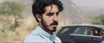 Movie still from “The Wedding Guest” (2018), directed by Michael Winterbottom – A person with a mustache; Close Up shot, Over the shoulder angle