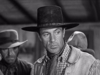 Movie still from “The Westerner” (1940), directed by William Wyler – A black and white photo of a man wearing a cowboy hat; Close Up shot, Low angle