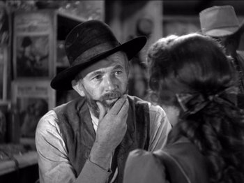 Movie still from “The Westerner” (1940), directed by William Wyler – An old man wearing a hat talking to a young girl; Close Up shot, Over the shoulder angle