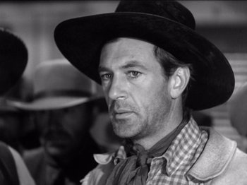 Movie still from “The Westerner” (1940), directed by William Wyler – Black and white photograph of a man wearing a cowboy hat; Close Up shot, Low angle
