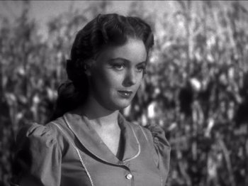 Movie still from “The Westerner” (1940), directed by William Wyler – An old black and white photo of a young woman; Close Up shot, Low angle