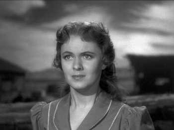 Movie still from “The Westerner” (1940), directed by William Wyler – An old black and white photo of a young woman; Close Up shot, Low angle