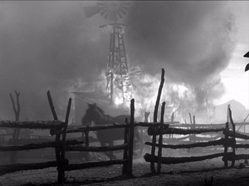 Movie still from “The Westerner” (1940), directed by William Wyler – A black and white photo of a windmill in the background; Wide shot, Low angle