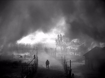 Movie still from “The Westerner” (1940), directed by William Wyler – A man is walking through a field in the fog; Wide shot, High angle