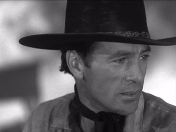 Movie still from “The Westerner” (1940), directed by William Wyler – A black and white photo of a man wearing a cowboy hat; Close Up shot, Over the shoulder angle