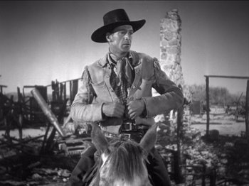 Movie still from “The Westerner” (1940), directed by William Wyler – A man on a horse in a black and white photo; Medium shot, Low angle