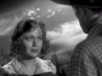 Movie still from “The Westerner” (1940), directed by William Wyler – An old black and white photo of a man and a woman; Close Up shot, Over the shoulder angle