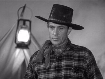 Movie still from “The Westerner” (1940), directed by William Wyler – A man wearing a cowboy hat and a plaid shirt; Medium shot, Low angle