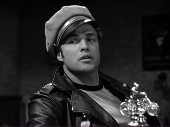 Movie still from “The Wild One” (1953), directed by Laslo Benedek – Black and white photograph of a man wearing a leather jacket; Close Up shot, Low angle