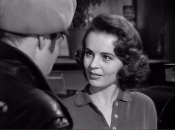 Movie still from “The Wild One” (1953), directed by Laslo Benedek – An old photo of a woman talking to a man; Close Up shot, Over the shoulder angle