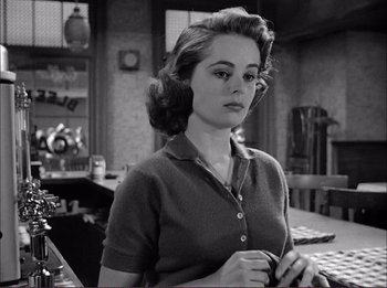 Movie still from “The Wild One” (1953), directed by Laslo Benedek – A black - and - white photo of a woman in a kitchen; Close Up shot, Low angle