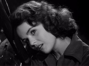 Movie still from “The Wild One” (1953), directed by Laslo Benedek – An old photo of a woman in a military uniform; Close Up shot, Low angle