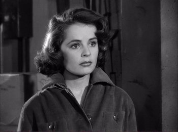 Movie still from “The Wild One” (1953), directed by Laslo Benedek – A black and white photo of a woman in a jacket; Close Up shot, High angle