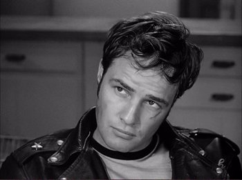 Movie still from “The Wild One” (1953), directed by Laslo Benedek – Black and white photograph of a man in a leather jacket; Close Up shot, High angle