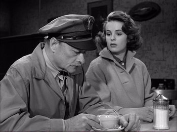 Movie still from “The Wild One” (1953), directed by Laslo Benedek – An old photo of a man and a woman drinking coffee; Medium shot, High angle