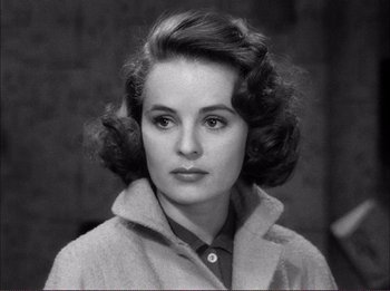 Movie still from “The Wild One” (1953), directed by Laslo Benedek – A black and white photo of a woman in a coat; Close Up shot, High angle