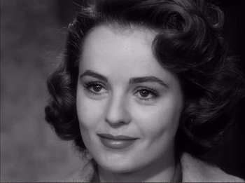 Movie still from “The Wild One” (1953), directed by Laslo Benedek – An old photo of an older woman with big hair; Close Up shot, Over the shoulder angle